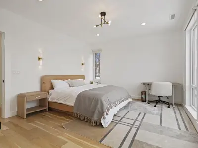 a bedroom with a bed and a desk and a chair at Modern living on the Quinnipiac River in New Haven