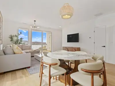a living room with a table and a couch at Modern living on the Quinnipiac River in New Haven