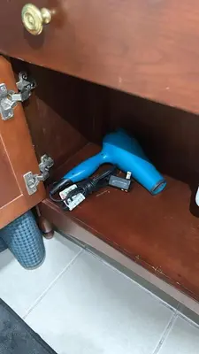 a blue object is sitting under a desk at Retro 2 bedroom basement APT with free parking in New Rochelle