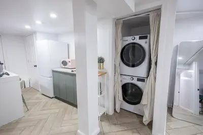 a laundry room with a washer and dryer in it at Retro 2 bedroom basement APT with free parking in New Rochelle