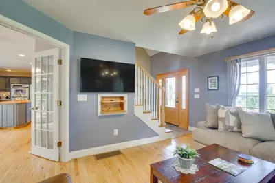 a living room with a couch and a tv at New Milford Home 29 Mi to Lime Rock Park! in New Milford