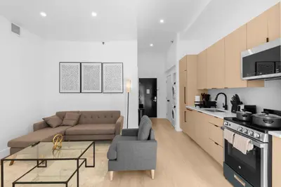 a kitchen and living room with a couch and a table at 19-4G 2BR 2Baths Luxury Apt East Village in New York