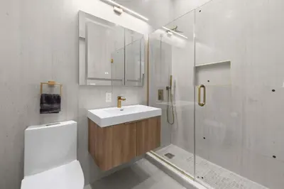 a white bathroom with a sink and a shower at 19-4G 2BR 2Baths Luxury Apt East Village in New York