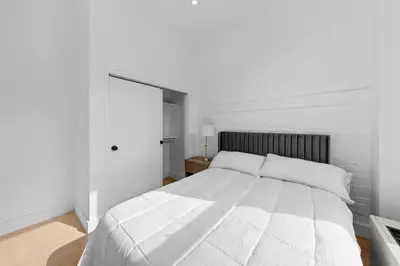 a white bedroom with a large white bed in it at 19-5D 2BR 2Baths Luxury Apt East Village in New York