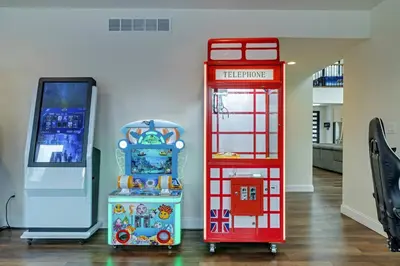 a room with a red phone booth and a machine at The Perfect Pocono Escape in Pocono Farms East