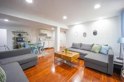 a living room with a couch and a table at Bright 3bed basement with backyard & free parking in Yonkers