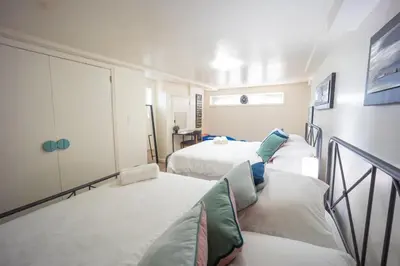 a room with three beds in a room at Bright 3bed basement with backyard & free parking in Yonkers
