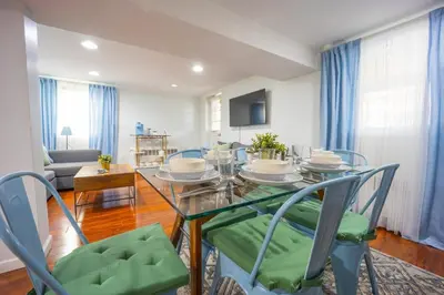 a dining room with a glass table and chairs at Bright 3bed basement with backyard & free parking in Yonkers