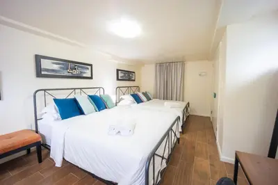 a hotel room with two beds and a table at Bright 3bed basement with backyard & free parking in Yonkers
