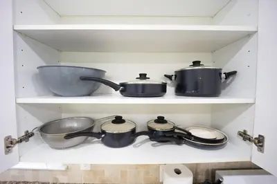 two pots and pans on a shelf in a kitchen at 3bedroom APT with balcony & free street parking in Yonkers