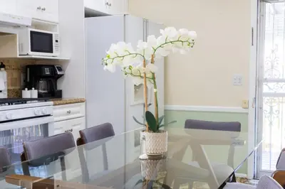 a dining room with a glass table and chairs at 3bedroom APT with balcony & free street parking in Yonkers
