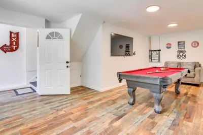 a room with a pool table and a couch at Hot Tub and Game Room Wooded Poconos Retreat in Tobyhanna
