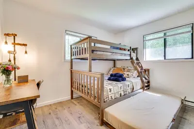 a bedroom with two bunk beds and a desk at Hot Tub and Game Room Wooded Poconos Retreat in Tobyhanna