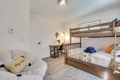 a living room with a bunk bed and a couch at Hot Tub and Game Room Wooded Poconos Retreat in Tobyhanna