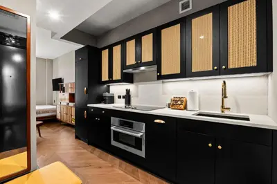 a kitchen with black cabinets and a sink at Freeman 602 by Rove Travel - Condo with Shared Amenities in New York