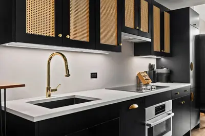 a kitchen with a sink and black cabinets at Freeman 603 by Rove Travel - Studio with Shared Amenities in New York