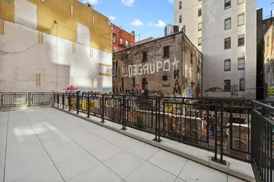 a walkway in the middle of a city with buildings at Freeman 201 by Rove Travel - 2BR Condo with Shared Amenities in New York