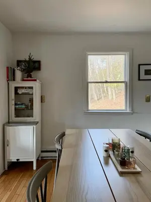 a living room with a wooden table and a window at Fireplace Catskill Views Overlook Lake Cabin in Parksville