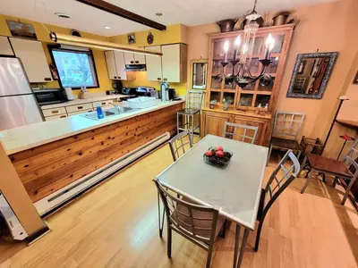 a kitchen with a table and chairs and a counter at Shawnee Ski Mountain View Jacuzzi Townhouse in East Stroudsburg