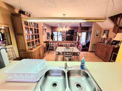 a kitchen with a sink and a dining room at Shawnee Ski Mountain View Jacuzzi Townhouse in East Stroudsburg