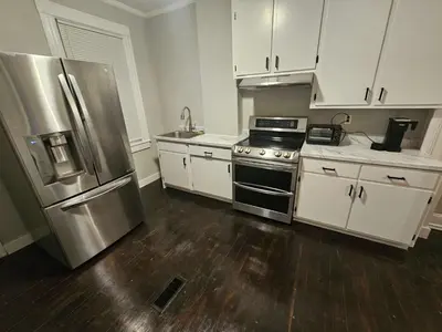 a kitchen with white cabinets and a stainless steel refrigerator at Apartment in Middletown-Wesleyan102 in Middletown