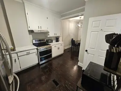 a kitchen with white cabinets and a stove top oven at Apartment in Middletown-Wesleyan102 in Middletown