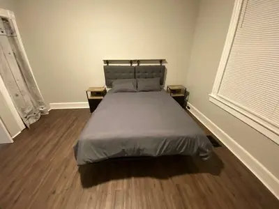 a bedroom with a bed and a wooden floor at Apartment in Middletown-Wesleyan102 in Middletown