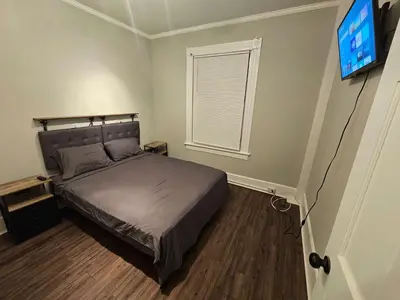 a bedroom with a bed and a flat screen tv at Apartment in Middletown-Wesleyan102 in Middletown