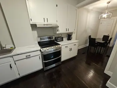 a kitchen with white cabinets and a stove top oven at Apartment in Middletown-Wesleyan102 in Middletown