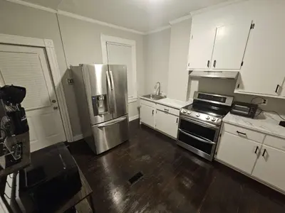 a kitchen with a stainless steel refrigerator and white cabinets at Apartment in Middletown-Wesleyan102 in Middletown
