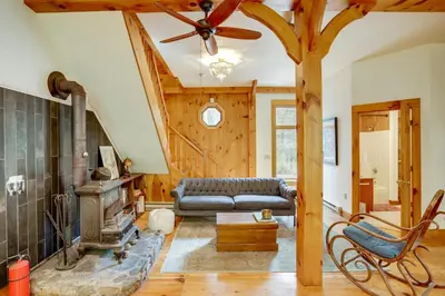 a living room with a couch and a fireplace at Secluded Family Getaway with On-Site Creek in Hawley in Hawley