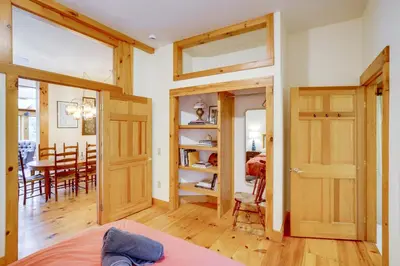 a room with wooden doors and a dining room at Secluded Family Getaway with On-Site Creek in Hawley in Hawley