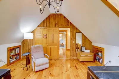 a room with a staircase with a chair and a desk at Secluded Family Getaway with On-Site Creek in Hawley in Hawley