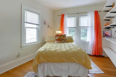 a bedroom with a bed and two windows at Walk to Hudson River Waterfront Newburgh Home in Newburgh