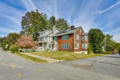 a large brick house on a street at Walk to Hudson River Waterfront Newburgh Home in Newburgh