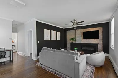 a living room with a couch and a fireplace at 20 min to NYC, Newly Renovated, Private Driveway in Little Ferry