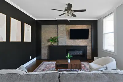 a living room with a couch and a fireplace at 20 min to NYC, Newly Renovated, Private Driveway in Little Ferry