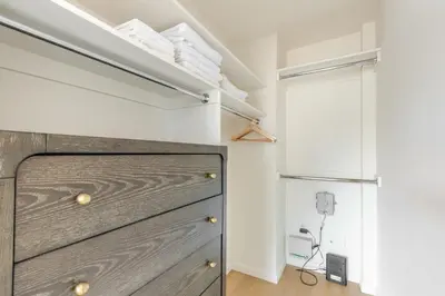a kitchen with a wooden dresser and a refrigerator at Blueground Upper West Side fitness nr Central Park NYC-1994 in New York