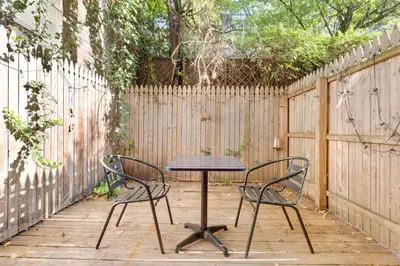 two chairs and a table in front of a fence at Blueground Hells Kitchen terrace nr Times Square NYC-2063 in New York
