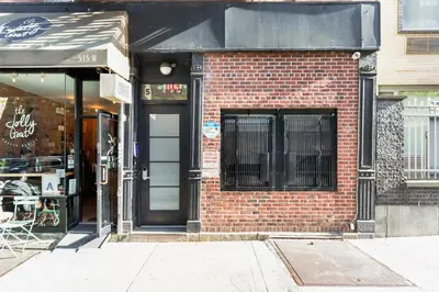 a store front of a brick building with a door at Blueground Hells Kitchen terrace nr Times Square NYC-2063 in New York
