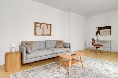 a living room with a couch and a table at Blueground Brooklyn Heights view nr Brooklyn Bridge NYC-1987 in Brooklyn