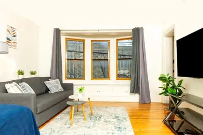 a living room with a couch and a tv at Spacious 1 bedroom Downtown in Albany