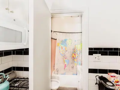 a kitchen with a map of the world on a shower curtain at Spacious 1 bedroom Downtown in Albany