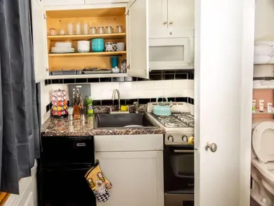 a small kitchen with a sink and a stove at Spacious 1 bedroom Downtown in Albany