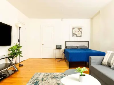 a living room with a bed and a couch at Spacious 1 bedroom Downtown in Albany