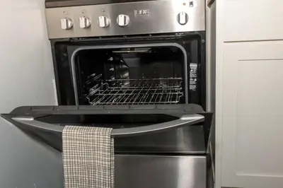 an oven with its door open in a kitchen at Downtown Studio Very Cozy in Albany