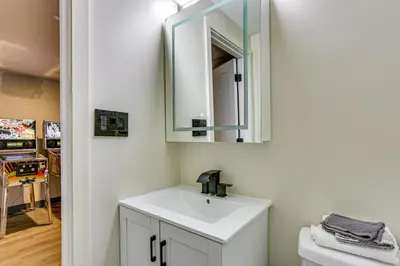 a bathroom with a sink and a mirror at Luxury Home with Game Room, 4 Mi to Bushkill Falls! in Saw Creek