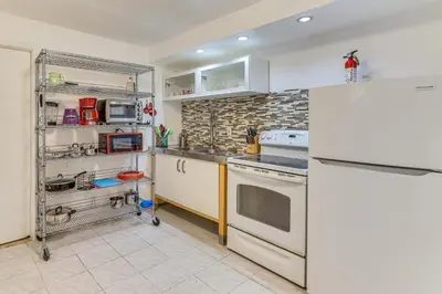 a kitchen with white cabinets and a white refrigerator at Easy NYC Commute Guttenberg Getaway Near Parks in Guttenberg
