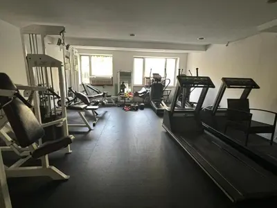 a gym with several tread machines in a room at 1 BEDROOM WITH SLEEPING IN LIVING ROOM Williamburg in Brooklyn