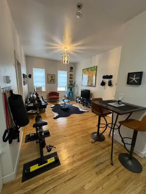 a room with a gym with tables and chairs at Modern Stay in Downtown Jersey City, Close to NYC! in Jersey City